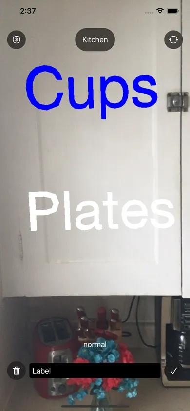 Floating in front of a kitchen cabinet, there is a label that says "cups", which is higlighted in blue. Below that, there is a label that says "plates"